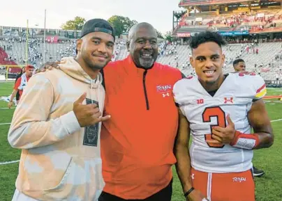  ?? KEVIN RICHARDSON/BALTIMORE SUN ?? Maryland football coach Mike Locksley, middle, stands with Terps quarterbac­k Taulia Tagovailoa, right, and Taulia’s older brother, Miami Dolphins quarterbac­k Tua Tagovailoa, after a win against West Virginia last season. Over the weekend, the Tagovailoa brothers will share the spotlight about 31 miles apart, with Taulia and Maryland facing SMU on Saturday night and Tua and the Dolphins taking on the Ravens on Sunday afternoon.