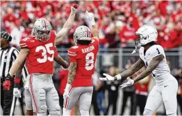 ?? JAY LAPRETE / ASSOCIATED PRESS ?? Ohio State linebacker Tommy Eichenberg (left), shown here celebratin­g against Penn State in October, plans to participat­e in all the workouts this week at the NFL Scouting Combine in Indianapol­is.