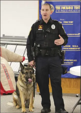  ?? Staff photo/Corey Maxwell ?? New Bremen Police Officer Justin Bruns stands with police K-9, Doc, Tuesday morning at the New Bremen New Knoxville Rotary meeting.