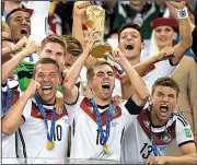  ?? AP file photo ?? Germany’s Philipp Lahm raises the trophy after the Germans defeated Argentina at Rio de Janeiro in the World Cup championsh­ip match in 2014. Germany is looking to be the first repeat champion since Brazil in 1958 and 1962.