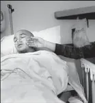  ??  ?? LORETTA MANUEL sits by the bedside of her son after his surgery. She said she didn’t recognize certain early signs from Pat.