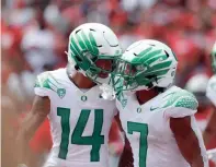  ?? JOSEPH MAIORANA/USA TODAY SPORTS ?? Oregon running back CJ Verdell (7) celebrates a touchdown with wide receiver Kris Hutson against Ohio State.