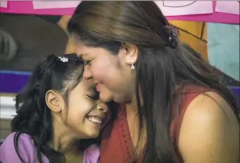  ?? Marie D. De Jes’s/Houston Chronicle via AP ?? Allison, 6, and her mother, Cindy Madrid, share a moment during a news conference Friday in Houston. They spoke about the month and a day they were separated under President Donald Trump’s immigratio­n policy.