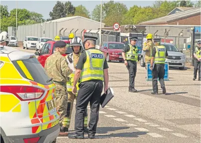  ??  ?? Police and bomb disposal experts at Elliot Industrial Estate in Arbroath after the discovery of a live military device.