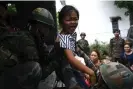  ?? ?? Indian soldiers help evacuate a girl during the ethnic riots in Manipur state. Photograph: Arun Sankar/AFP/Getty Images