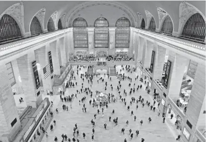  ??  ?? Travelers cross the main concourse of Grand Central Terminal in New York on Jan. 9, as seen from a bird’s eye view through a window near the ceiling. | KATHY WILLENS~AP GRAND CENTRAL CENTENNIAL: Located on 42nd Street and Park Avenue in Manhattan....