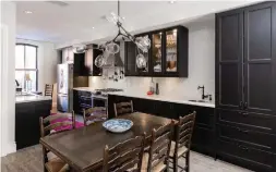  ?? MITCHELL HUBBLE PHOTOS ?? The open-concept dining room features a hardwood floor, a modern light fixture and a floor-toceiling pantry, all of it blending into the kitchen.