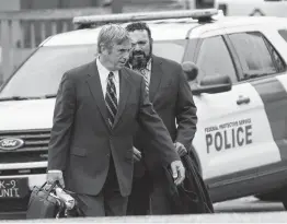  ?? Billy Calzada / San Antonio Express-News ?? Former Harlandale ISD trustee Joshua Cerna (rear) walks to the federal courthouse with his lawyer, Chris Gober, for his sentencing Tuesday.