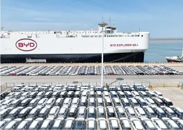  ?? PHOTOS BY REUTERS ?? A aerial view of BYD electric vehicles waiting to be loaded on a ship for export to Brazil, at Lianyungan­g port in Jiangsu province on Thursday.