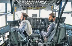  ??  ?? Taliban fighters sit in the cockpit of an Afghan Air Force aircraft at the airport in Kabul on Tuesday.AFP