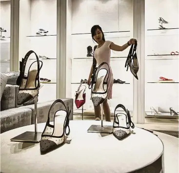  ?? – Bloomberg ?? Growing market: A file picture shows women’s shoes on display inside a Christian Dior SE store in Shanghai. Toledano says China is growing in priority for the Paris-based company, which has gained market share in the Asian country.