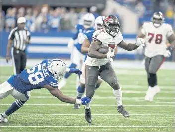  ?? MICHAEL CONROY — THE ASSOCIATED PRESS ?? Tampa Bay Buccaneers’ Leonard Fournette (7) runs past Indianapol­is Colts’ Bobby Okereke (58) during the second half of an NFL football game, Sunday in Indianapol­is.