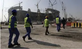  ?? Photograph: Hassan ?? Workers at Lusail stadium, which hosts the World Cup final.