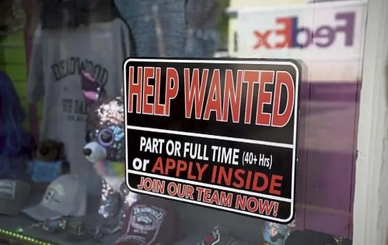  ?? David Zalubowski, The Associated Press ?? A sign for workers hangs in the window of a shop along Main Street in Deadwood, S.D. U.S. employers added 559,000 jobs in May, an improvemen­t from April’s sluggish gain but still evidence that many companies are struggling to find enough workers as the economy rapidly recovers from the pandemic recession.