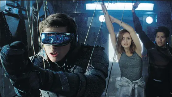  ?? WARNER BROS. ?? Tye Sheridan, left, Olivia Cooke and Win Morisaki star in Ready Player One, one of many big-screen features showing a bleak world on the brink of social collapse.