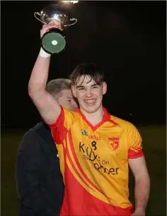  ??  ?? Dylan Furlong of Sarsfields raises the cup aloft.