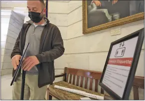  ?? (Arkansas Democrat-Gazette/Staton Breidentha­l) ?? Brent Stamp, director of facilities for the state Capitol, assembles signs Friday to inform visitors about elevator etiquette ahead of the start of the legislativ­e session.