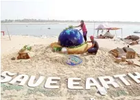  ?? Reuters ?? Students make a sand sculpture on the Earth Day on the banks of the river Yamuna in Allahabad, Uttar Pradesh, on Sunday.