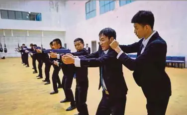  ?? AFP PIC ?? An instructor correcting a trainee’s action during a training session at the Genghis Security Academy in Tianjin recently.