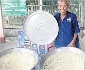  ??  ?? Kamol Pruksa cooking the rice snack.