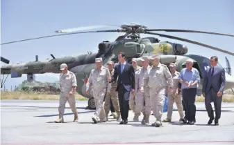  ?? Syrian Presidency ?? Syrian President Bashar Assad visits the Russian Hmeimim Air Base on Tuesday in Latakia province. The Trump administra­tion is divided over whether to try to slow Assad’s advances.