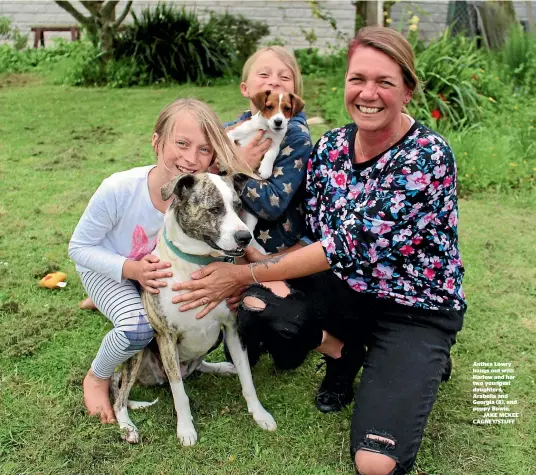  ??  ?? Anthea Lowry hangs out with Harlow and her two youngest daughters, Arabella and Georgia (8), and puppy Bowie.JAKE MCKEE CAGNEY/STUFF