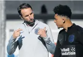  ?? Picture: AFP/PAUL ELLIS ?? THE ARCHITECT: England manager Gareth Southgate, left, talks with midfielder Jadon Sancho. Sancho has been rewarded with his first national call-up.