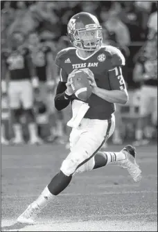  ?? THE ASSOCIATED PRESS ?? Texas A&M quarterbac­k Johnny Manziel could become the first freshman to win the Heisman Trophy when it is awarded Saturday,