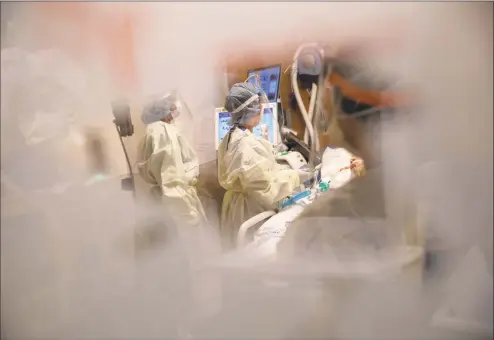  ?? John Moore / Getty Images ?? Nurses tend to a COVID-19 patient in a Stamford Hospital intensive care unit on April 24.