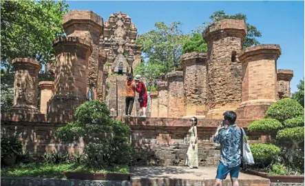  ?? ?? Tourist magnet: Tourists enjoying the sights at Ponagar Temple in the coastal resort town of Nha Trang. — bloomberg