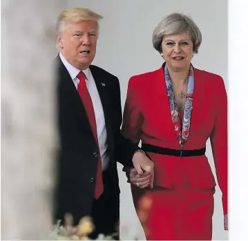 ?? CHRISTOPHE­R FURLONG / GETTY IMAGES ?? U.S. President Donald Trump and British Prime Minister Theresa May walk along the White House colonnade. May said the meeting was an indication of the importance of the relationsh­ip between the transatlan­tic allies.