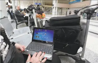  ?? Anwar Amro / AFP / Getty Images ?? Laptops and tablets will not be allowed in plane cabins on flights from Europe to the United States under a proposal being considered by President Trump’s administra­tion.