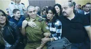  ?? (Miriam Alster/Flash90/pool) ?? FAMILY AND FRIENDS of Sgt. Elor Azaria offer emotional support in the Jaffa Military Court yesterday.