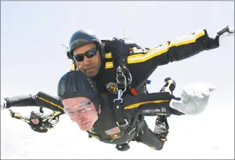  ?? SSG Joe Abeln / AP ?? In this photo provided by Army Golden Knights, former President George H. W. Bush, bottom, rides tandem with Sgt. Michael Elliott of the Army Golden Knights parachute team as he celebrates his 85th birthday with a parachute jump, Friday, June 12, 2009,...