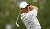  ?? SUE OGROCKI / AP ?? Rory McIlroy watches his tee shot during a practice round in Tulsa, Okla. The 2014 PGA Championsh­ip winner is looking for his fifth major title.