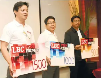  ?? (SUNSTAR FOTO/ARNI ACLAO) ?? NEW SERVICE. (From left) LBC Express Philippine operations SVP Oliver Valentin, LBC Money VP Achilles Reyes and LBC Express Visayas VP Leo Divinagrac­ia hold mock load cards during the launch of LBC TXT Remit.