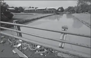  ?? The Associated Press ?? STORM DAMAGE: In this June 28, 2016, file photo, debris from floodwater­s litters a pedestrian bridge above Howard Creek along the 18th hole of the Old White Course at the Greenbrier Resort in White Sulphur Springs, W.Va. Last year’s Greenbrier Classic...