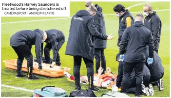  ?? CAMERASPOR­T - ANDREW KEARNS ?? Fleetwood’s Harvey Saunders is treated before being stretchere­d off