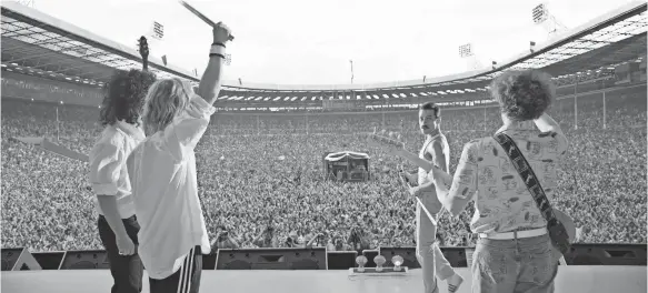  ?? 20TH CENTURY FOX ?? Queen’s Live Aid set is re-created by Gwilym Lee (as Brian May, from left), Ben Hardy (Roger Taylor), Rami Malek (Freddie Mercury) and Joe Mazzello (John Deacon). It is the centerpiec­e of the biopic “Bohemenian Rhapsody.”