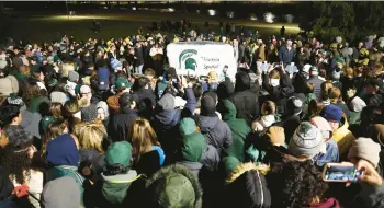  ?? SCOTT OLSON/GETTY ?? Students, faculty and others attend a vigil Feb. 15 at Michigan State University in East Lansing, Michigan.