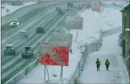  ?? FRANCISCO KJOLSETH /THE SALT LAKE TRIBUNE VIA AP ?? Runners negotiate snow covered paths along Interstate 80 in Salt Lake City, Utah., on Wednesday.