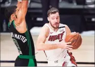  ?? Mark J. Terrill / Associated Press ?? Miami Heat’s Goran Dragic (7) and teammate Meyers Leonard have each decided to return to the Eastern Conference champions on two-year deals.