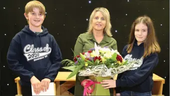  ??  ?? Boherbue National School 6th Class pupils Gavin Daly and Laoise Murphy making a presentati­on to their Class Teacher and School Principal Marie Casey during their recent Graduation Ceremony.