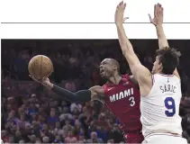  ??  ?? DWYANE WADE (#3) of the Miami Heat shoots the ball against Dario Saric (#9) of the Philadelph­ia 76ers in the fourth quarter during Game Two.