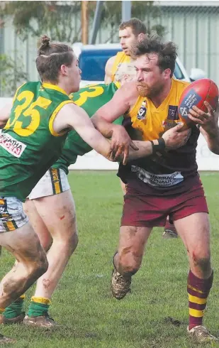  ??  ?? Drouin reserves captain Luke Ferguson brushes off a tackling attempt by Leongatha’s Jackson Harry. Ferguson led from the front to again be one of the Hawks’ best as they threw down a strong challenge to the top team.