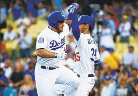  ?? Kent Nishimura Los Angeles Times ?? MAX MUNCY, left, and Cody Bellinger celebrate Muncy’s solo home run in the first inning. Muncy, who will participat­e in the home run derby next week, added a run-scoring single in the seventh inning, with the go-ahead run scoring on a throwing error.