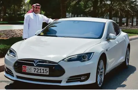  ?? Ahmed Kutty/Gulf News ?? Above and below right: Abu Dhabi-based Ajlaan Saeed, who owns a Tesla Model S bought last year. The car, which he bought after selling his Audi, had been imported, but never driven by the owner.