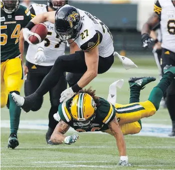  ?? JASON FRANSON/THE CANADIAN PRESS ?? Hamilton Tiger-Cats running back Mercer Timmis had a breakout game against Aaron Grymes and the Edmonton Eskimos Friday, rushing for 133 yards and two touchdowns.