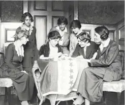  ??  ?? Women in Washington, D.C., sew stars on a suffrage flag symbolizin­g states ratifying the 19th Amendment granting them the right to vote. Tennessee would be the 36th, and last, star on the flag, as that number was what was needed to pass the amendment.
