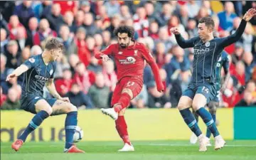  ?? REUTERS ?? Liverpool’s Mohamed Salah (centre) is challenged by Manchester City’s John Stones (left) and Aymeric Laporte on Sunday.